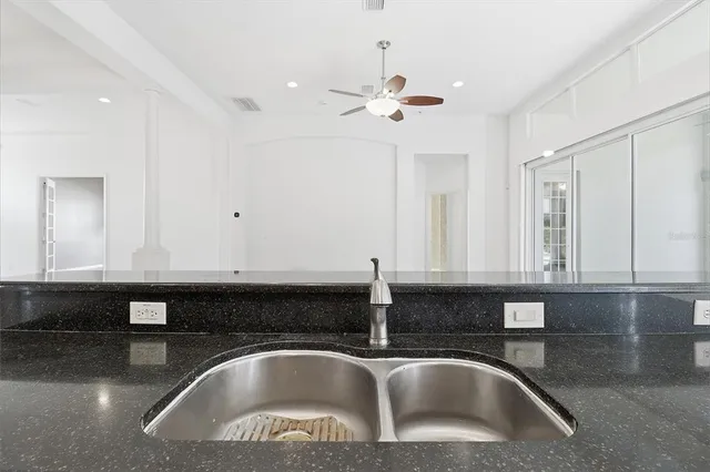 a bedroom with a bed and a chandelier fan