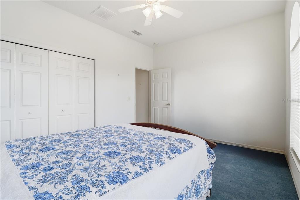 1683 North Shadowview Path Hernando, FL 34442 - Photo 26 of 56 a bedroom with a bed and a chandelier fan