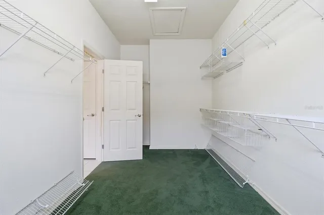 a living room with furniture large windows and wooden floor