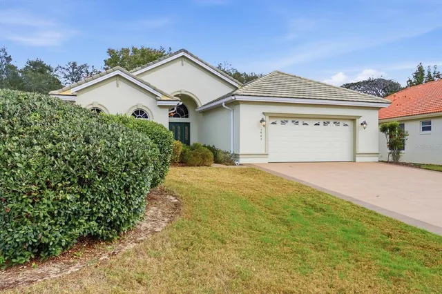 a view of a house with a yard and garage