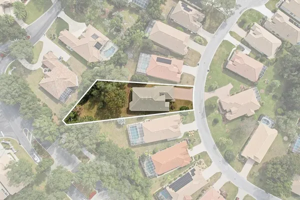 an aerial view of a residential houses with outdoor space