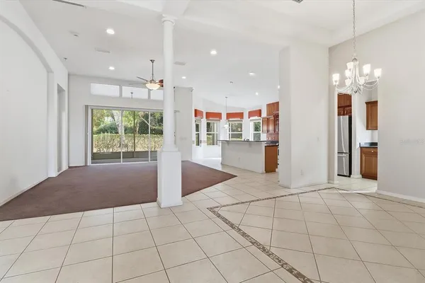 a view of a kitchen with refrigerator and windows