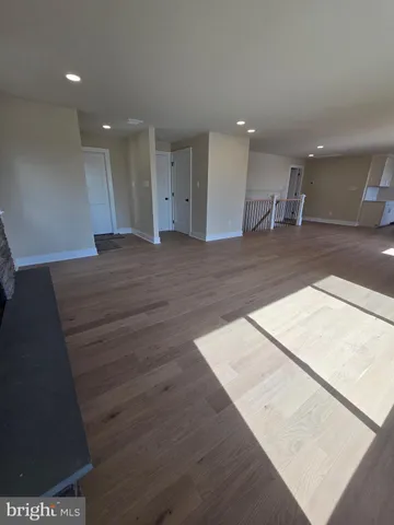 a large bedroom with a bed and a potted plant