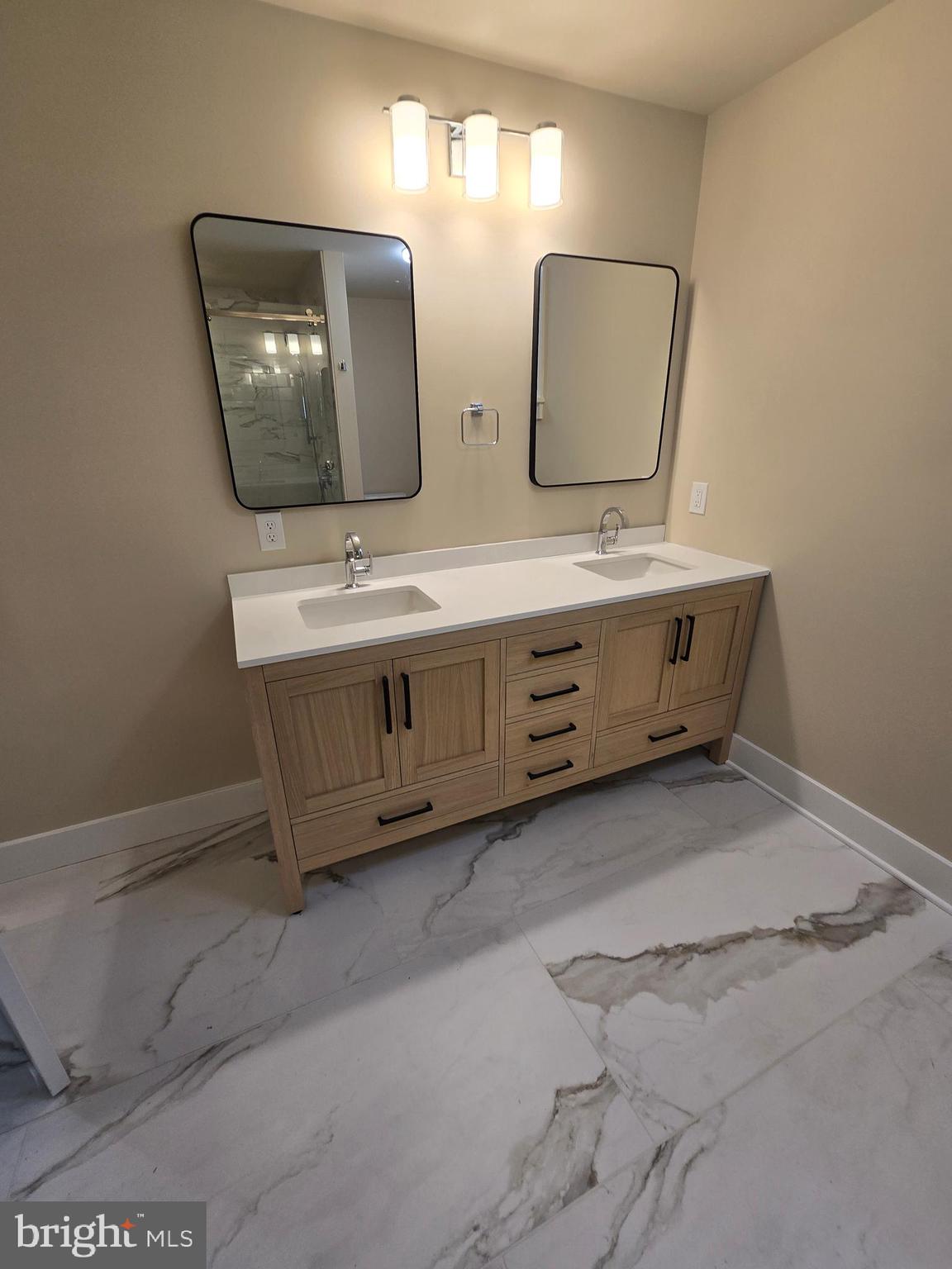 873 Ferry Road Doylestown, PA 18901 - Photo 24 of 38 a bathroom with double vanity sink and mirror