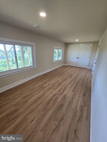 a spacious bathroom with a double vanity sink and a mirror