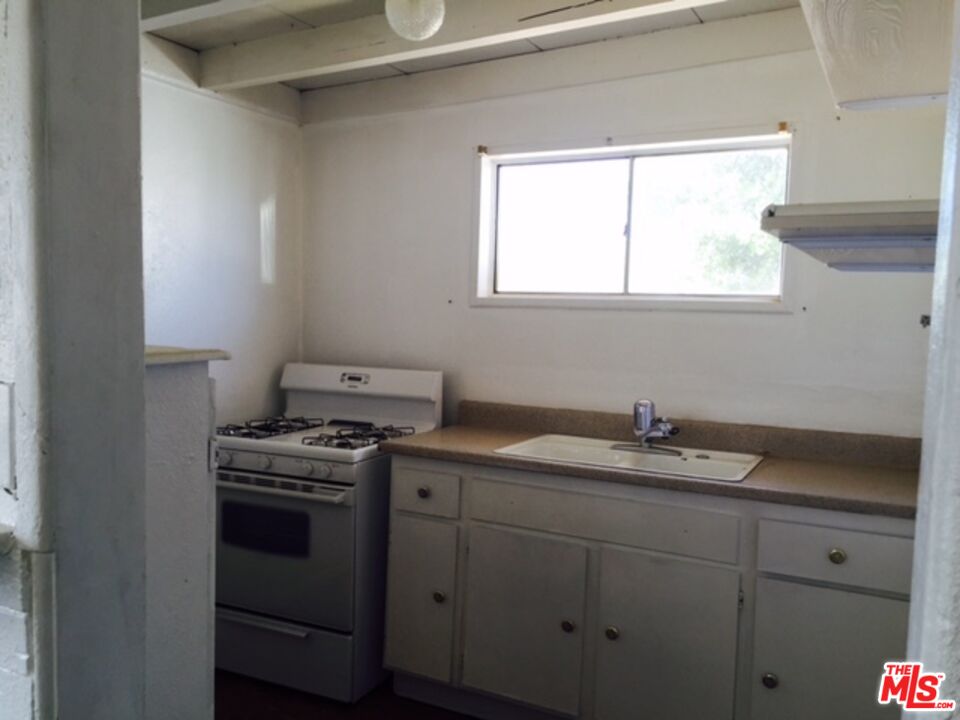 Fort Tejon Road Palmdale, CA 93552 - Photo 11 of 34 a kitchen with appliances cabinets and a window