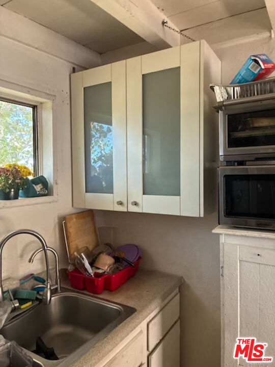 Fort Tejon Road Palmdale, CA 93552 - Photo 16 of 34 a kitchen with a sink and a microwave