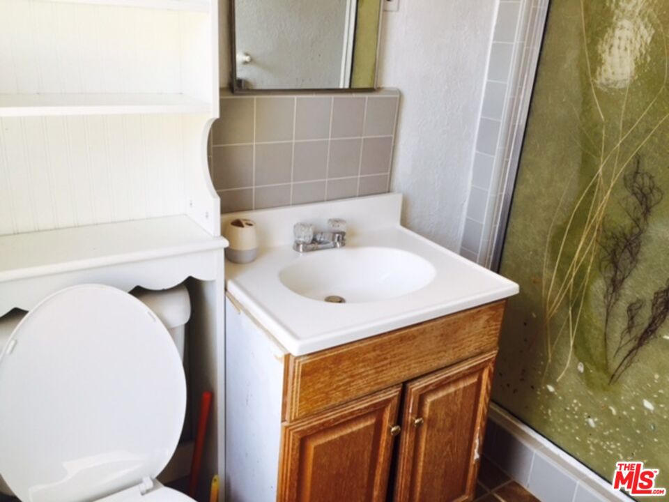 Fort Tejon Road Palmdale, CA 93552 - Photo 20 of 34 a bathroom with a sink a toilet and mirror