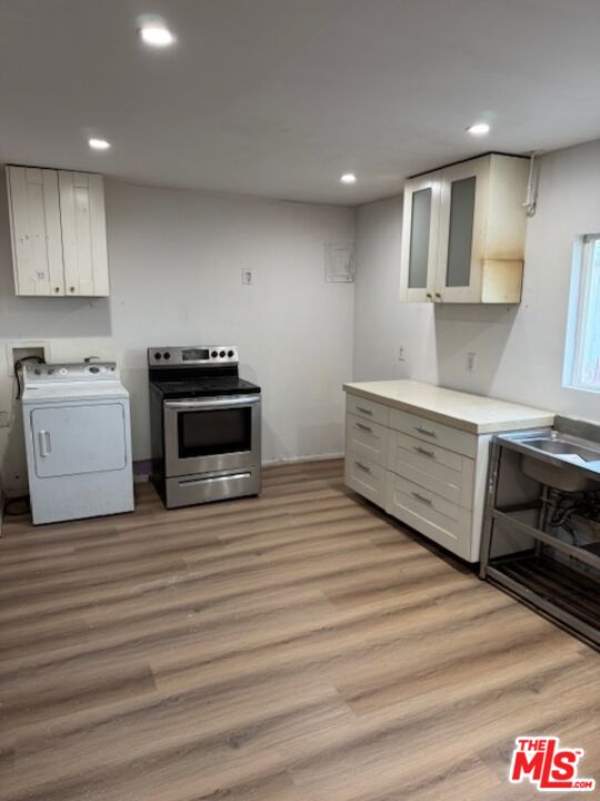 Fort Tejon Road Palmdale, CA 93552 - Photo 27 of 34 a kitchen with stainless steel appliances a stove and white cabinets