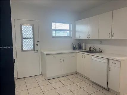 a kitchen with white cabinets
