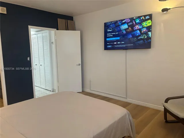 a bedroom with a bed and a wall painting