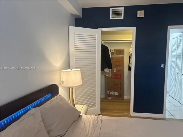 a bedroom with a bed and a lamp