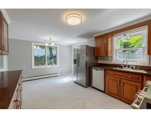6 Robin Road Billerica, MA 01821 - Photo 11 of 26 a kitchen with stainless steel appliances granite countertop a refrigerator a sink dishwasher and wooden cabinets