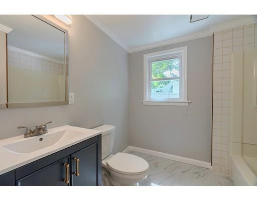 6 Robin Road Billerica, MA 01821 - Photo 12 of 26 a bathroom with a sink a toilet a mirror and a window