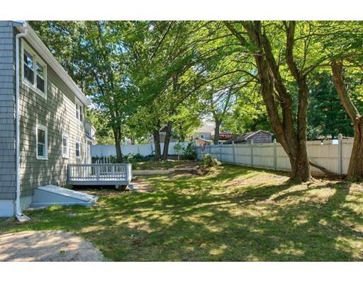 6 Robin Road Billerica, MA 01821 - Photo 24 of 26 a view of a backyard with table and chairs and wooden fence