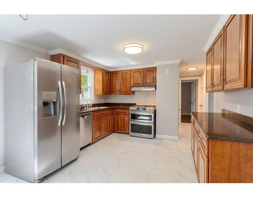 6 Robin Road Billerica, MA 01821 - Photo 8 of 26 a kitchen with stainless steel appliances granite countertop a refrigerator a stove and a sink