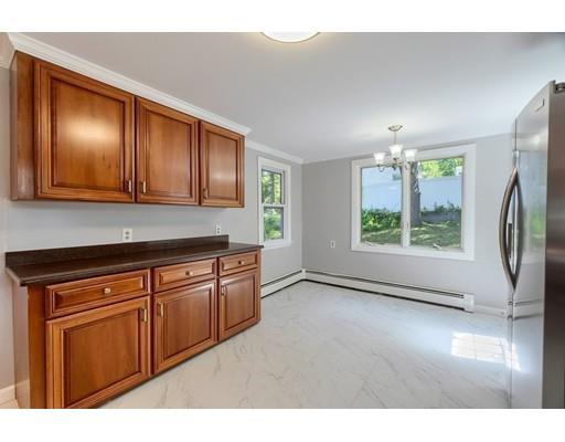 6 Robin Road Billerica, MA 01821 - Photo 10 of 26 a kitchen with stainless steel appliances granite countertop a refrigerator a sink dishwasher and wooden cabinets with wooden floor