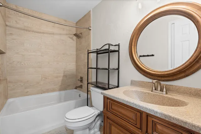 a bathroom with a sink a toilet and a mirror