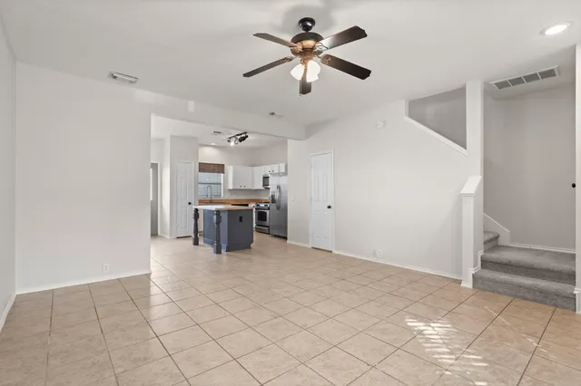a open kitchen with cabinets and stainless steel appliances