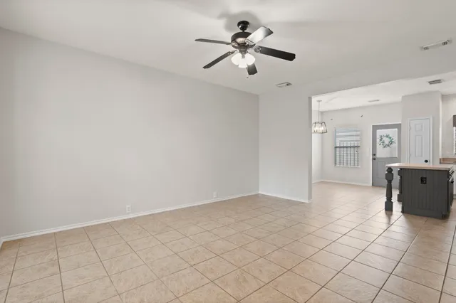 a view of a livingroom with a chandelier fan and furniture