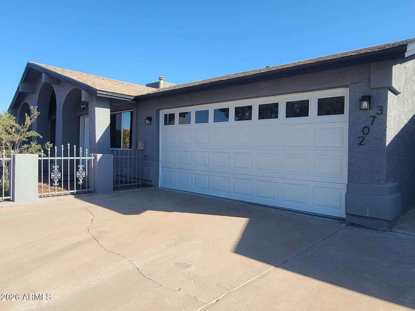 3702 East Thunderbird Road Phoenix, AZ 85032 - Photo 2 of 23 a front view of a house with a yard