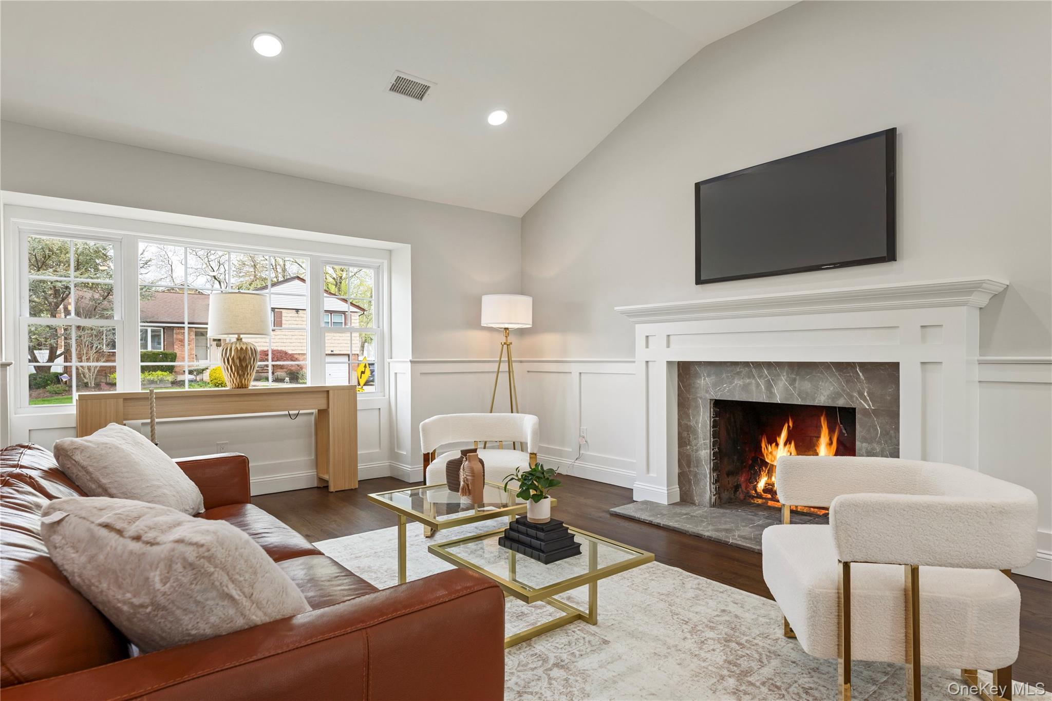 16 Eleanor Road Plainview, NY 11803 - Photo 6 of 28 Living area featuring a fireplace, large picture window, hard wood floors and recessed lighting