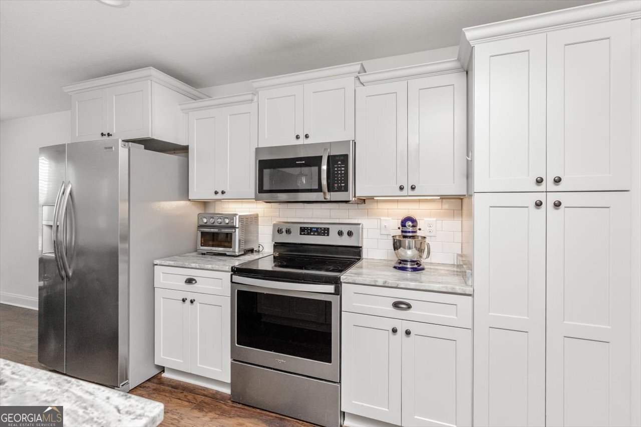 207 Kendall Court Perry, GA 31069 - Photo 16 of 45 a kitchen with cabinets stainless steel appliances and sink
