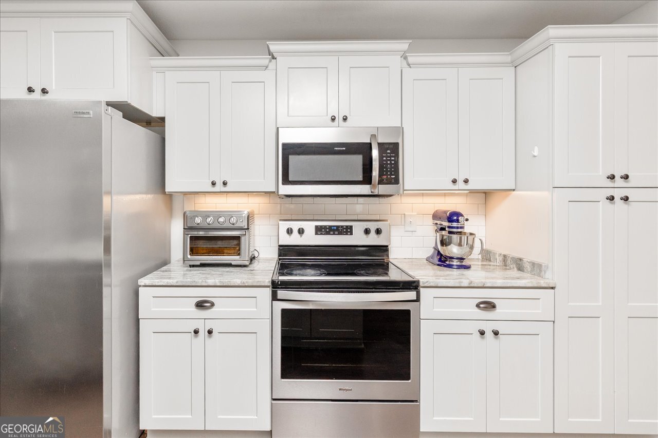 207 Kendall Court Perry, GA 31069 - Photo 17 of 45 a kitchen with cabinets stainless steel appliances and sink