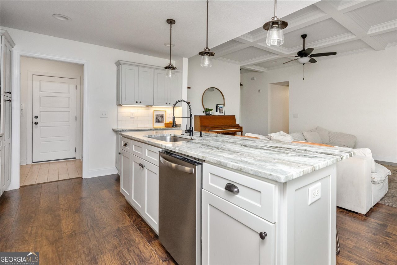 207 Kendall Court Perry, GA 31069 - Photo 19 of 45 a kitchen with granite countertop a sink appliances cabinets and wooden floor