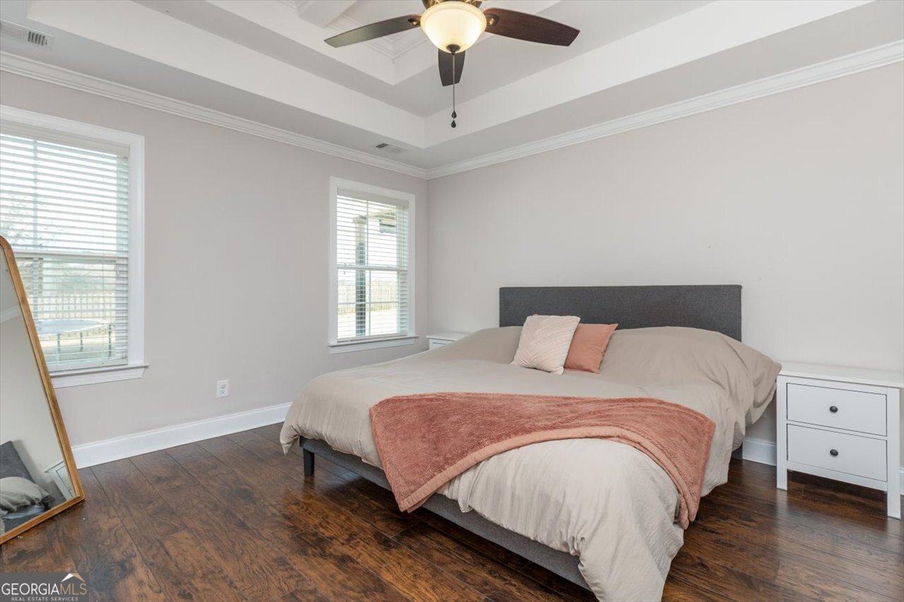 207 Kendall Court Perry, GA 31069 - Photo 23 of 45 a bedroom with a bed and a chandelier