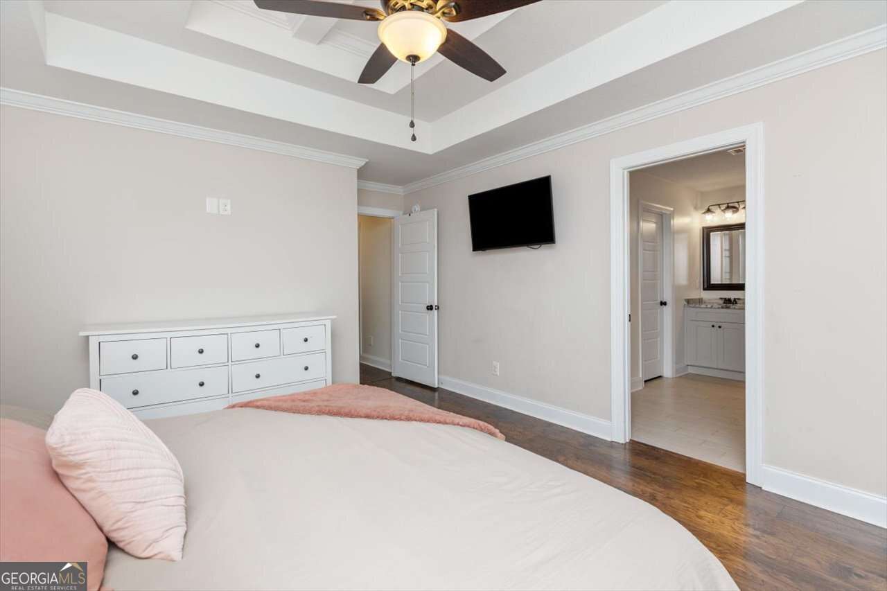 207 Kendall Court Perry, GA 31069 - Photo 25 of 45 a bedroom with a large bed and a flat screen tv