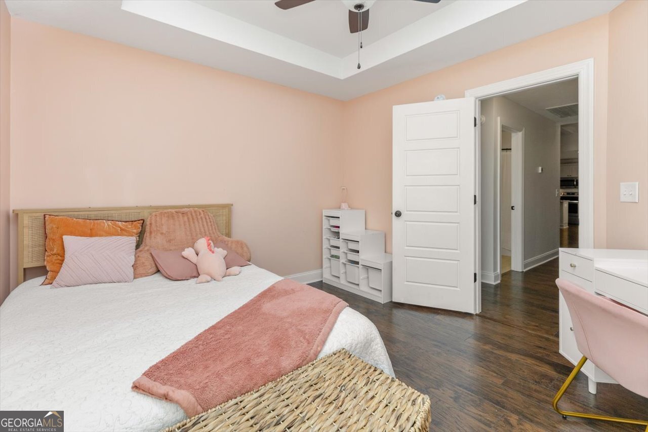 207 Kendall Court Perry, GA 31069 - Photo 38 of 45 a bedroom with a bed and wooden floor