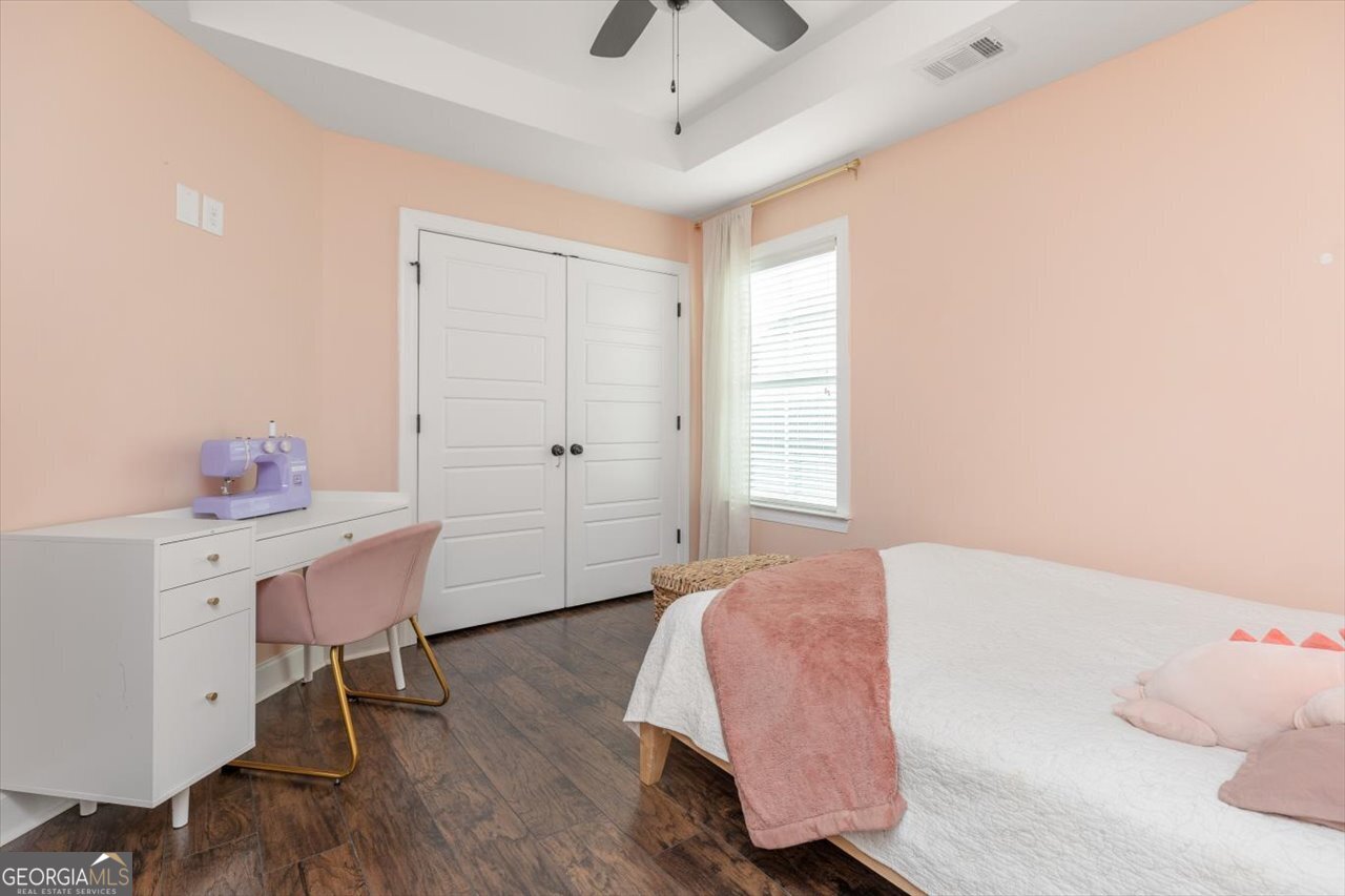 207 Kendall Court Perry, GA 31069 - Photo 39 of 45 a bedroom with a bed and a chandelier