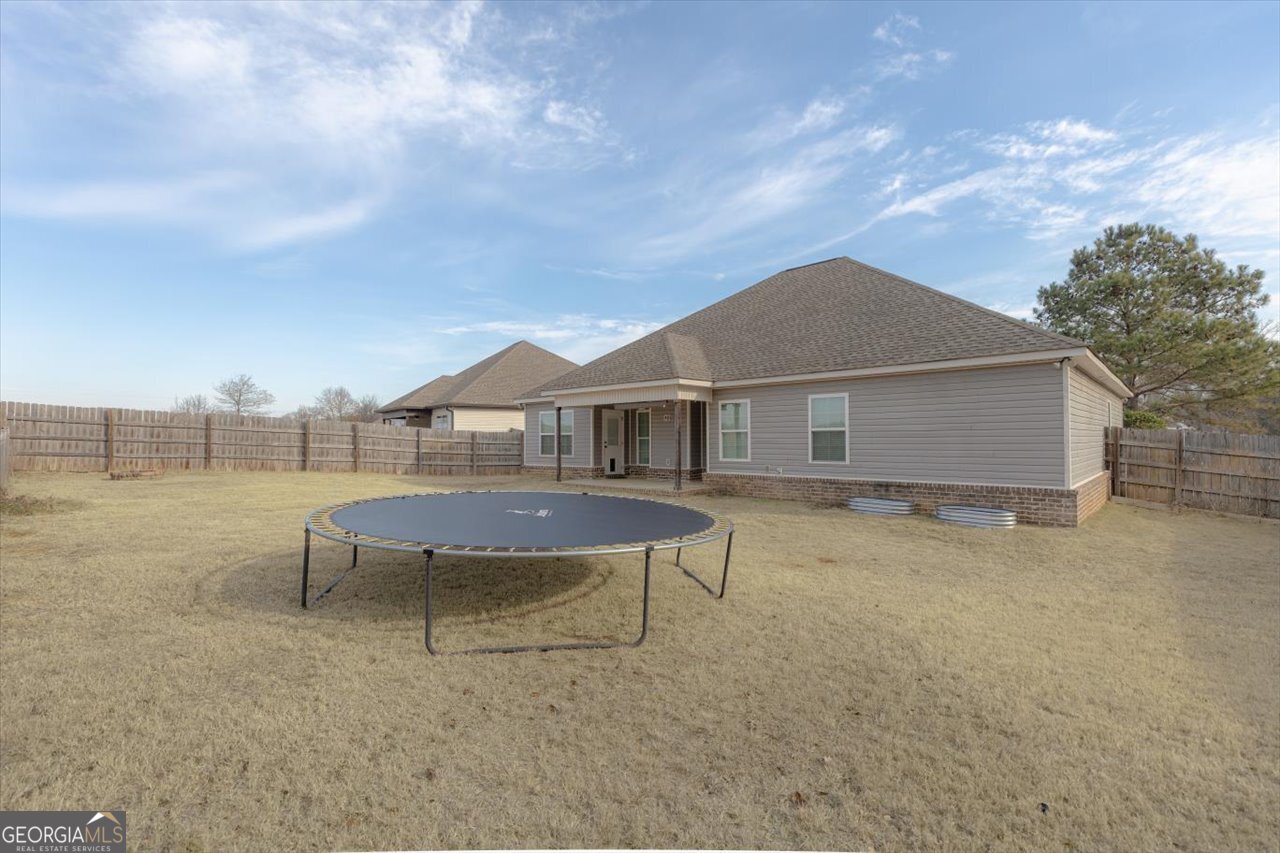 207 Kendall Court Perry, GA 31069 - Photo 43 of 45 a backyard of a house with table and chairs