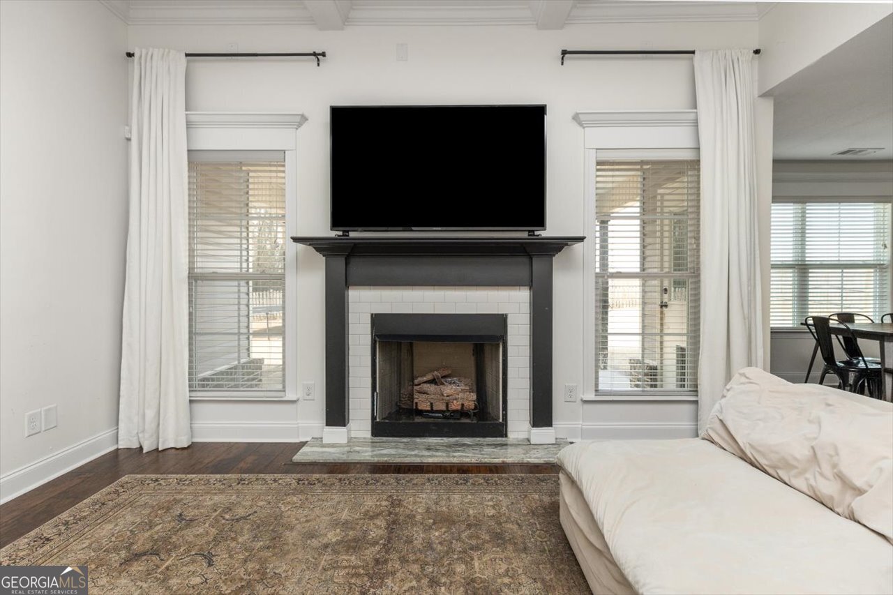 207 Kendall Court Perry, GA 31069 - Photo 7 of 45 a living room with a fireplace a flat screen tv and a large window