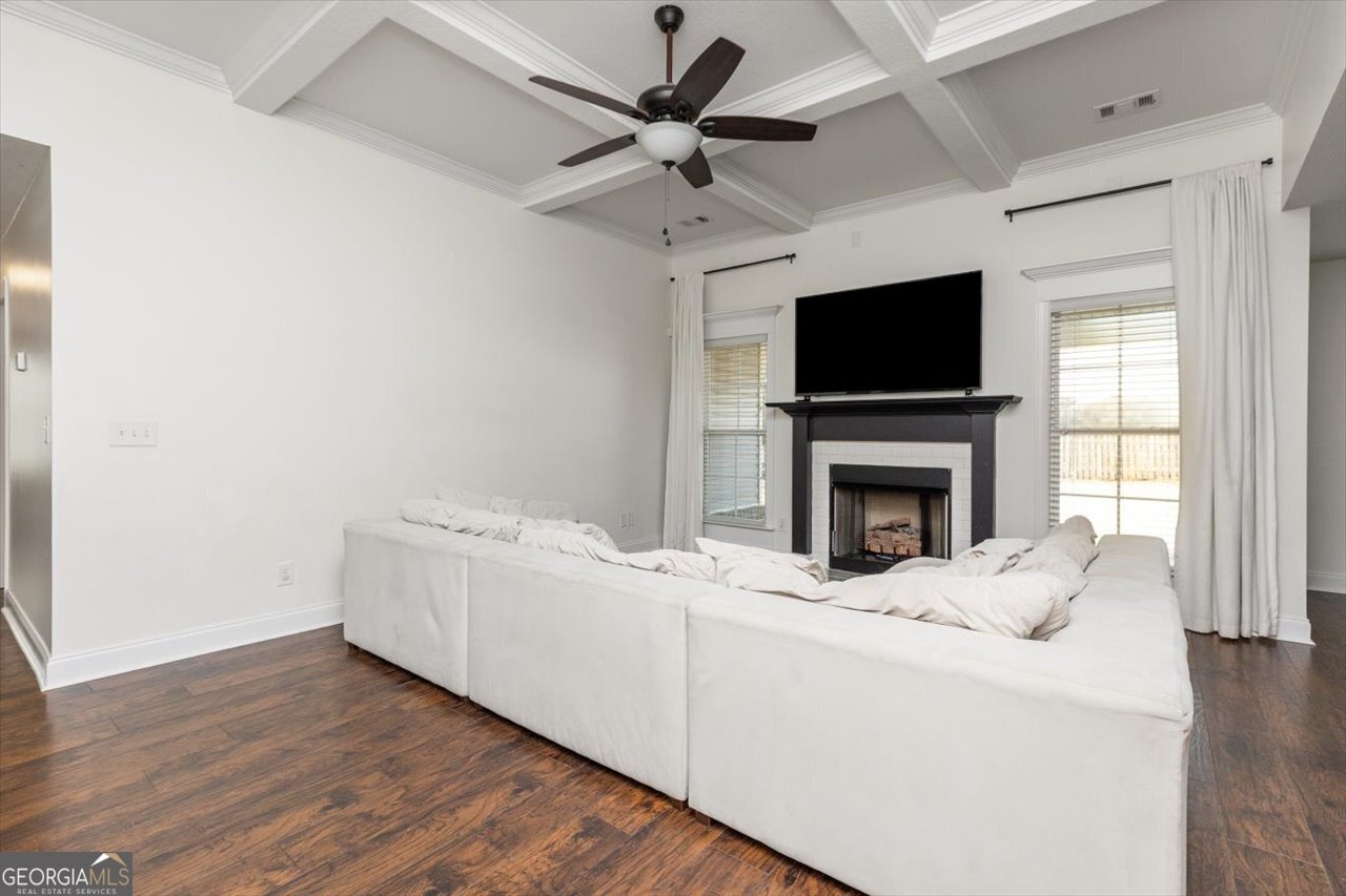 207 Kendall Court Perry, GA 31069 - Photo 8 of 45 a living room with furniture a fireplace and a flat screen tv