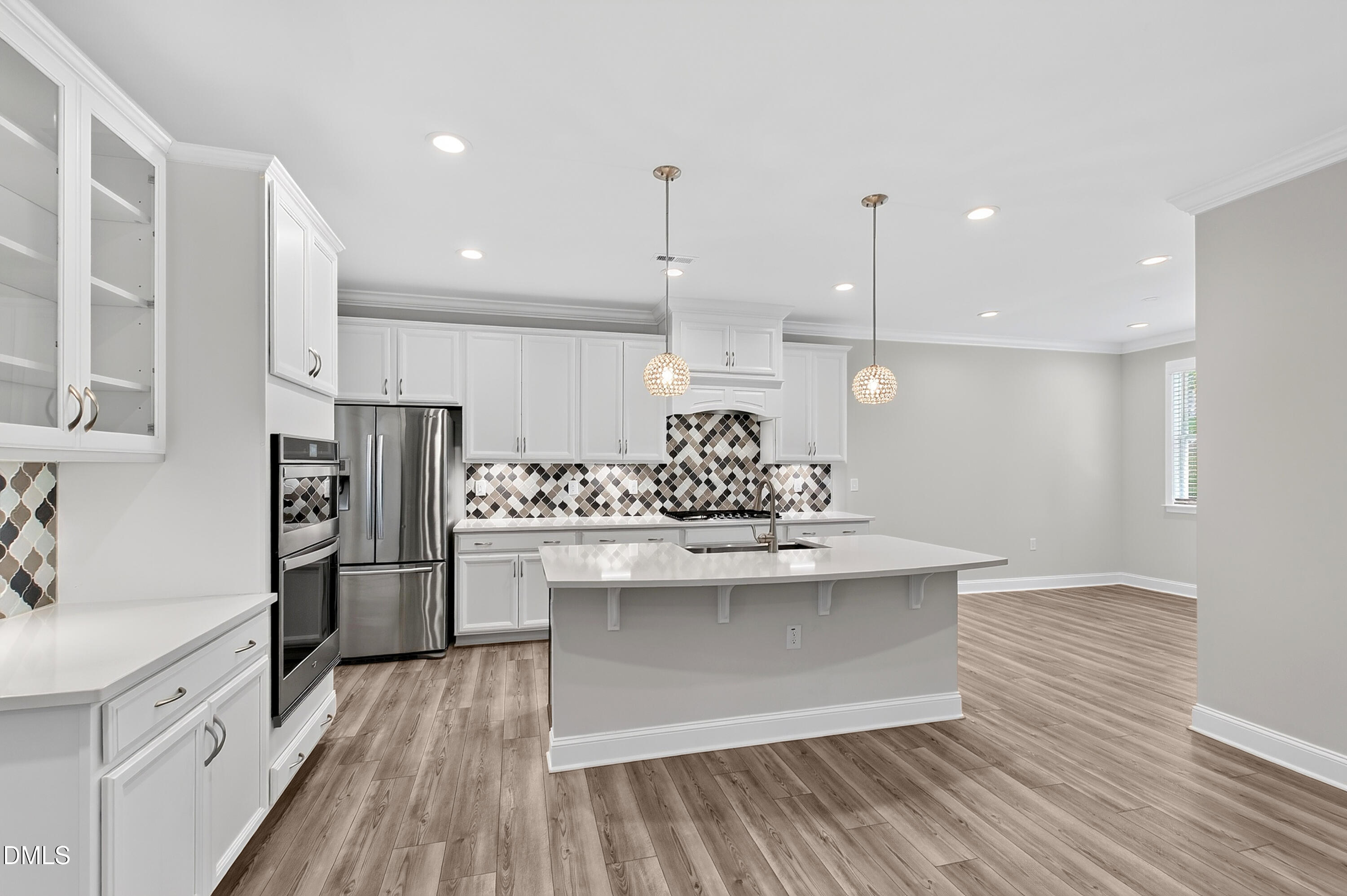 1300 Commons Ford Place Apex, NC 27539 - Photo 16 of 70 a kitchen with stainless steel appliances a kitchen island hardwood floor sink and stove