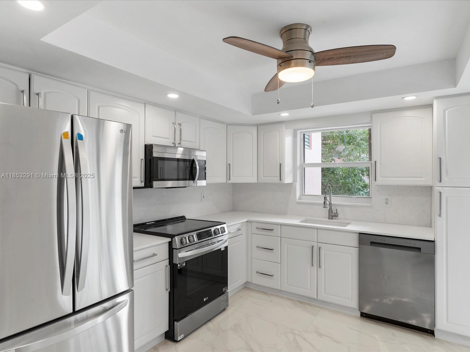 200 Northeast 12th Avenue, Unit 7C Hallandale Beach, FL 33009 - Photo 1 of 27 a kitchen with a sink stainless steel appliances and cabinets