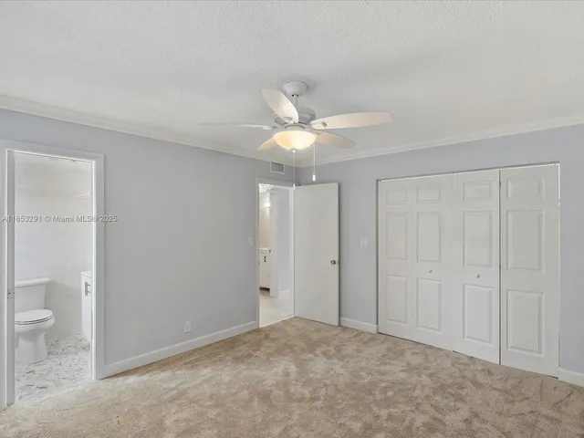 a view of an empty room and a bathroom