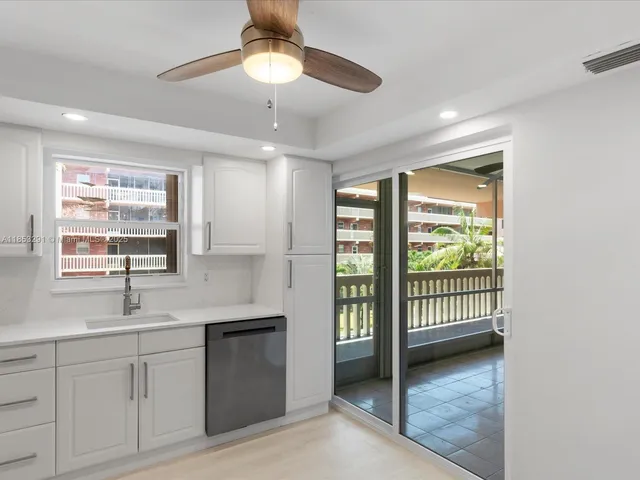 a kitchen with a sink window and cabinets