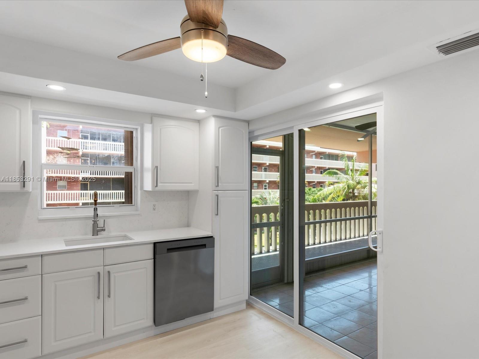 200 Northeast 12th Avenue, Unit 7C Hallandale Beach, FL 33009 - Photo 2 of 27 a kitchen with a sink window and cabinets