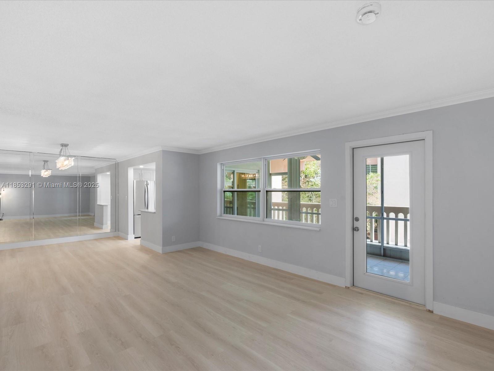 200 Northeast 12th Avenue, Unit 7C Hallandale Beach, FL 33009 - Photo 6 of 27 a view of an empty room with wooden floor and a window