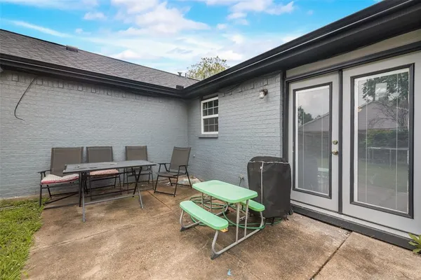 a backyard of a house with outdoor seating