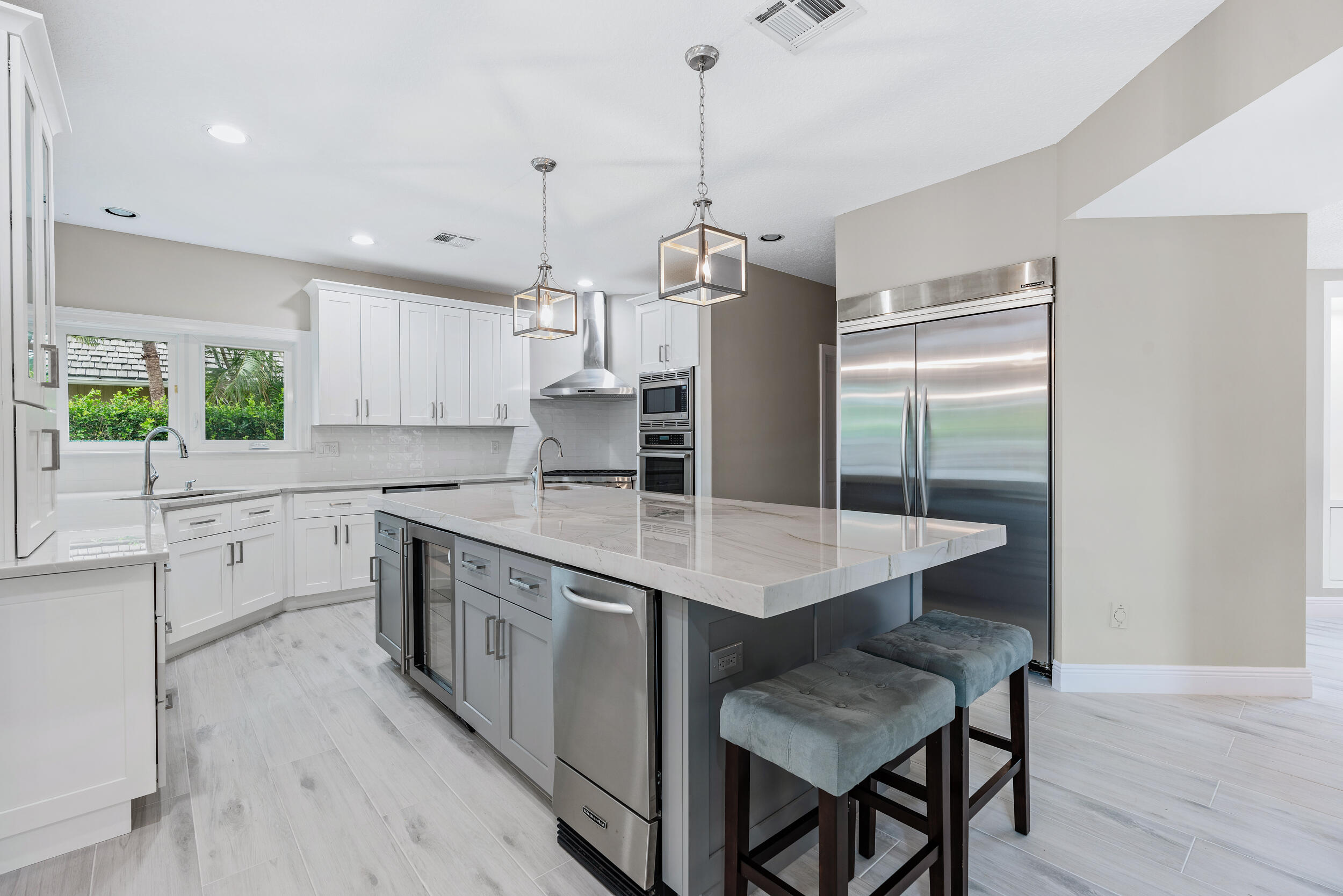 18169 Southeast Ridgeview Drive Tequesta, FL 33469 - Photo 11 of 51 a kitchen with a sink a counter space appliances and cabinets