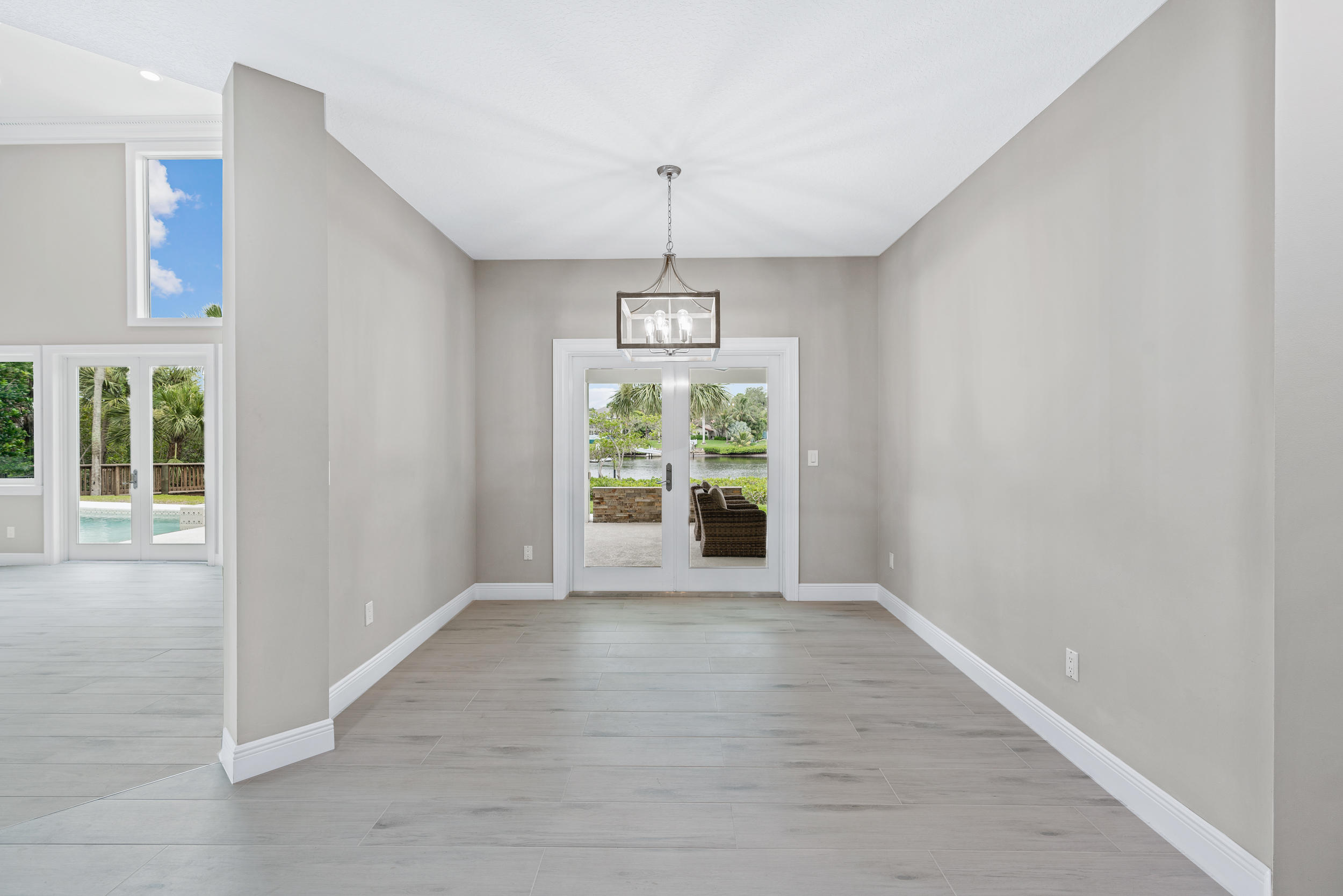 18169 Southeast Ridgeview Drive Tequesta, FL 33469 - Photo 14 of 51 a view of an empty room with wooden floor and a window