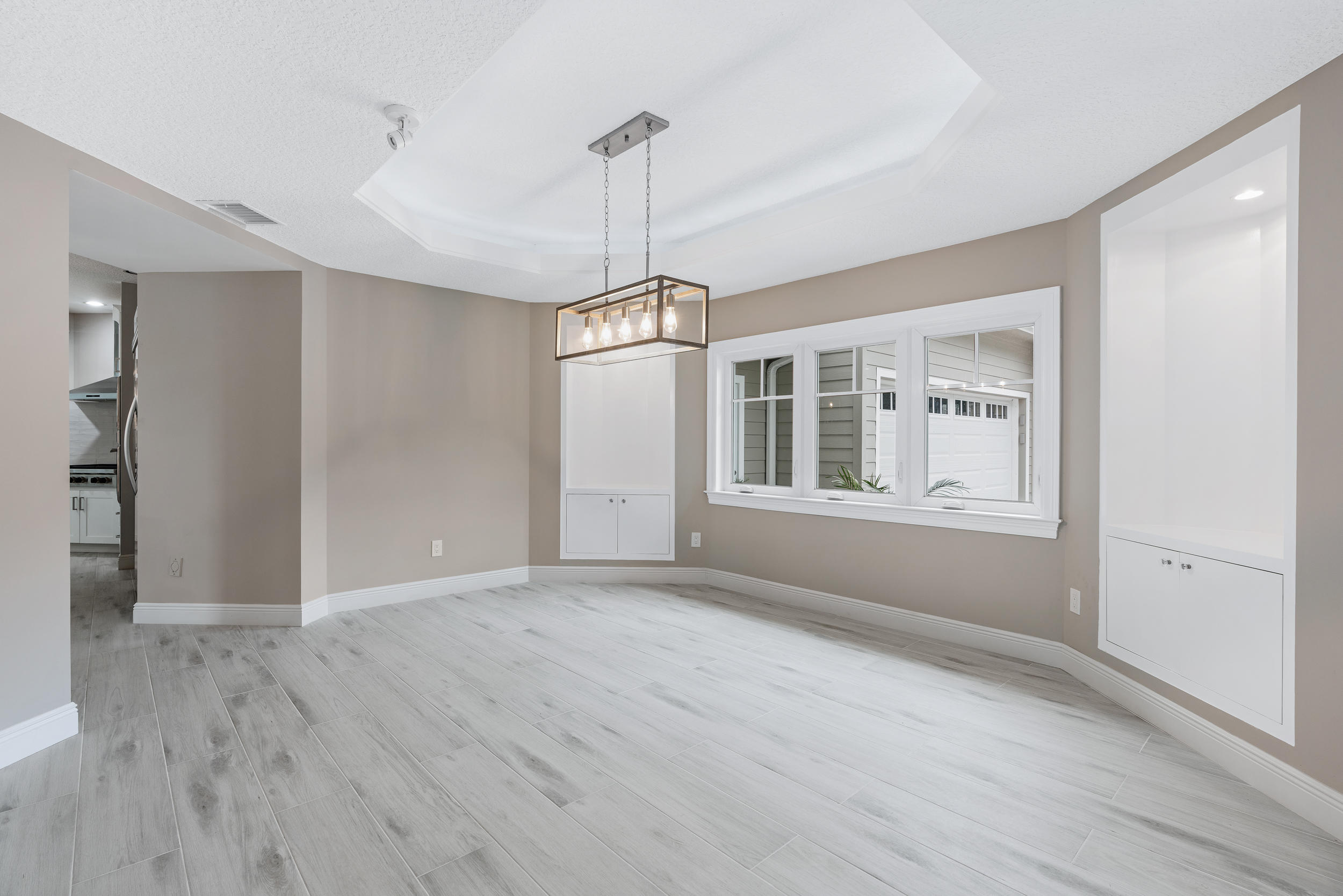 18169 Southeast Ridgeview Drive Tequesta, FL 33469 - Photo 19 of 51 a view of empty room with wooden floor and windows