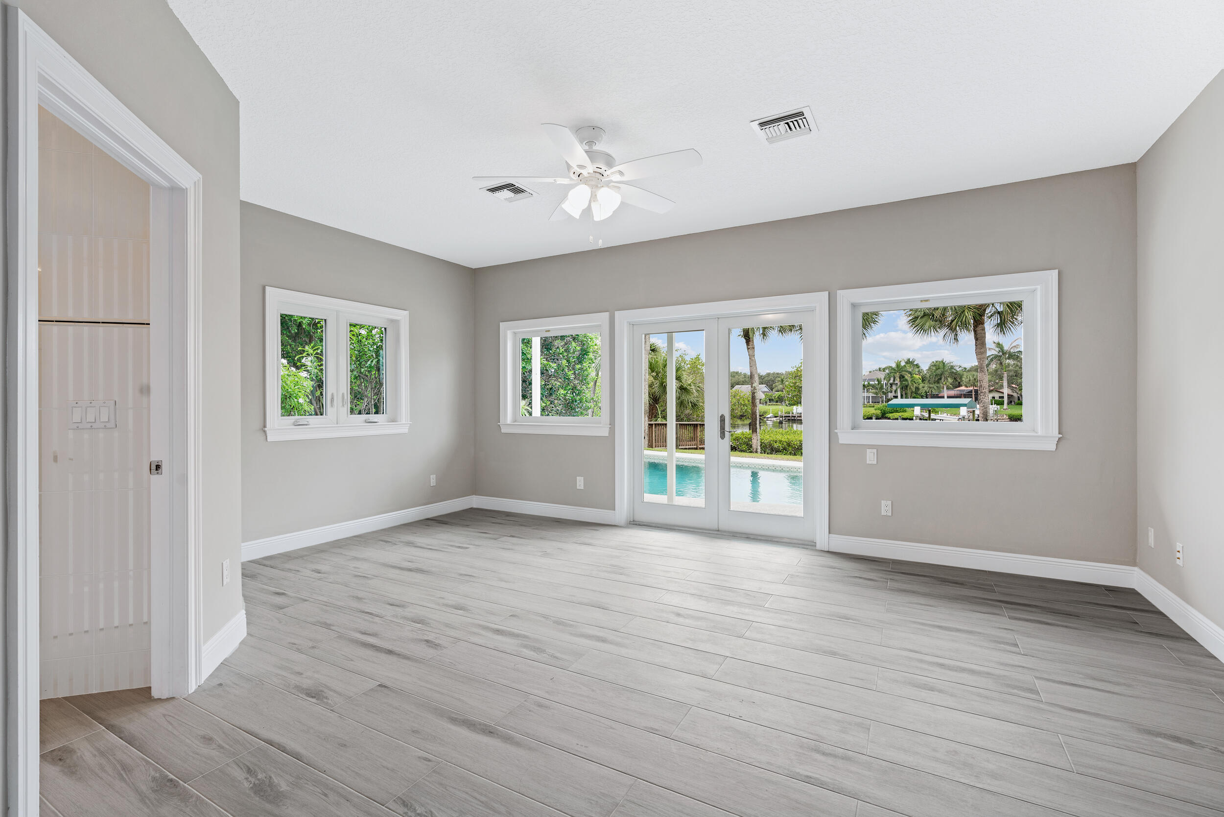 18169 Southeast Ridgeview Drive Tequesta, FL 33469 - Photo 20 of 51 a view of an empty room with wooden floor and a window