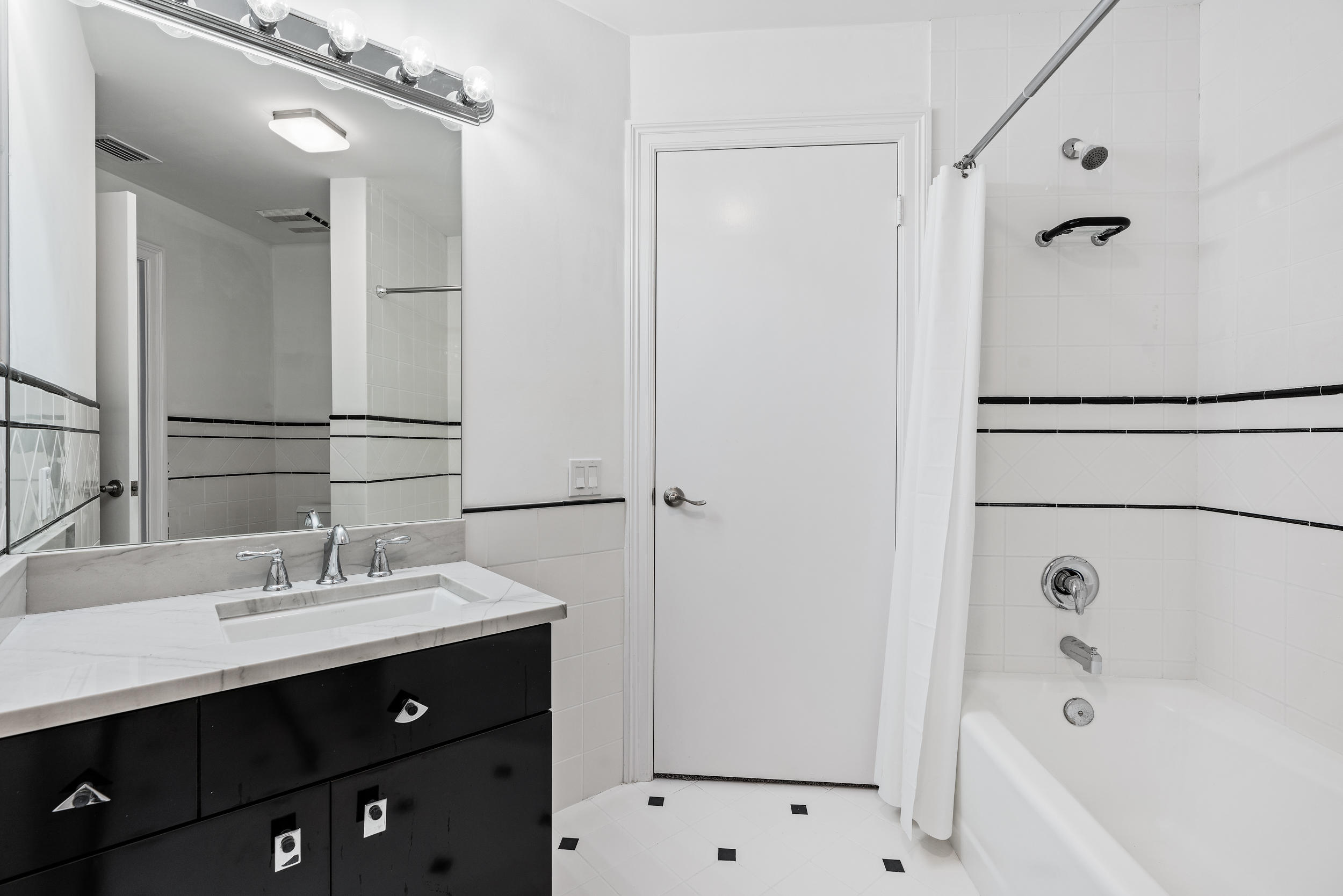 18169 Southeast Ridgeview Drive Tequesta, FL 33469 - Photo 28 of 51 a bathroom with a sink vanity tub and shower