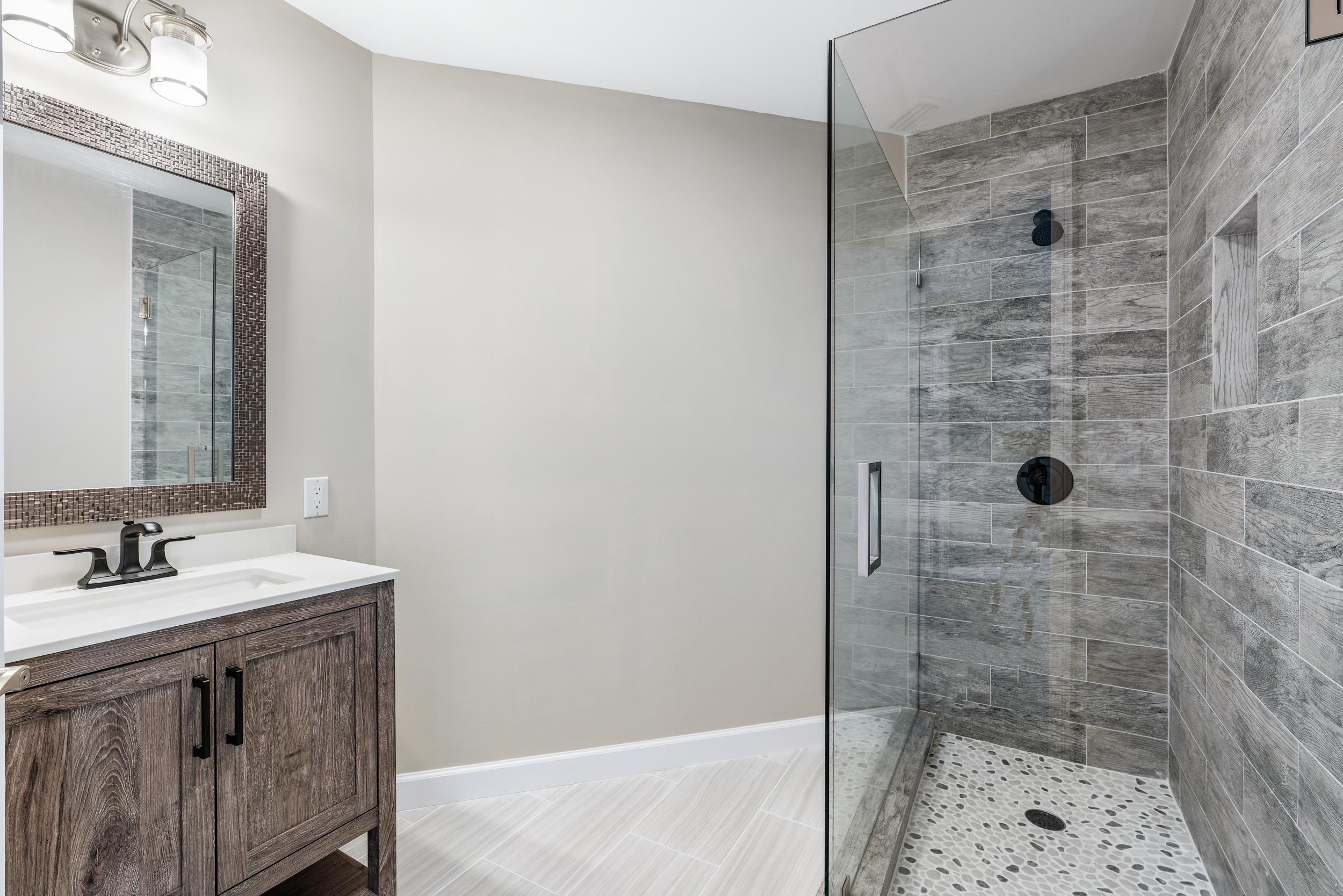 18169 Southeast Ridgeview Drive Tequesta, FL 33469 - Photo 31 of 51 a bathroom with a shower sink and vanity