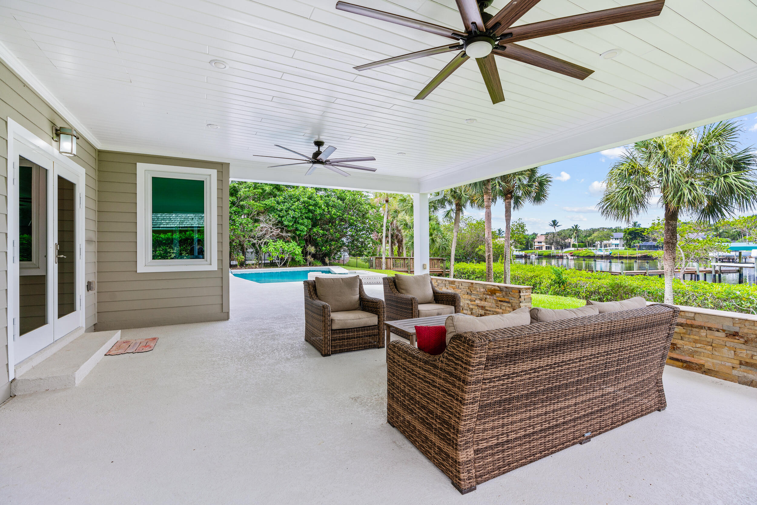 18169 Southeast Ridgeview Drive Tequesta, FL 33469 - Photo 37 of 51 a outdoor space with patio the couches and a dining table with garden view
